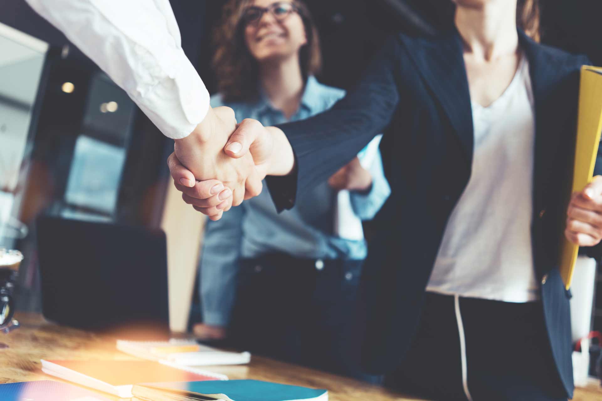 Young-business-people-shaking-hands-in-the-office